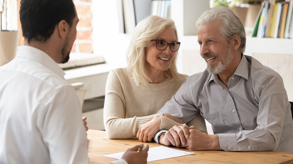 Older couple discussing their estate plan with their wealth advisor.