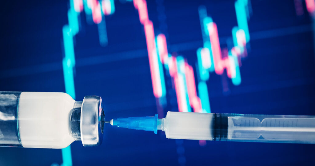 Vaccine needle and vial in front of a bright market performance line chart.