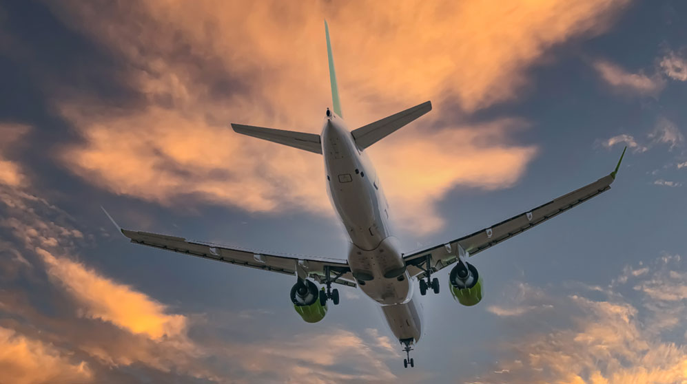 Jet airplane landing at dusk.