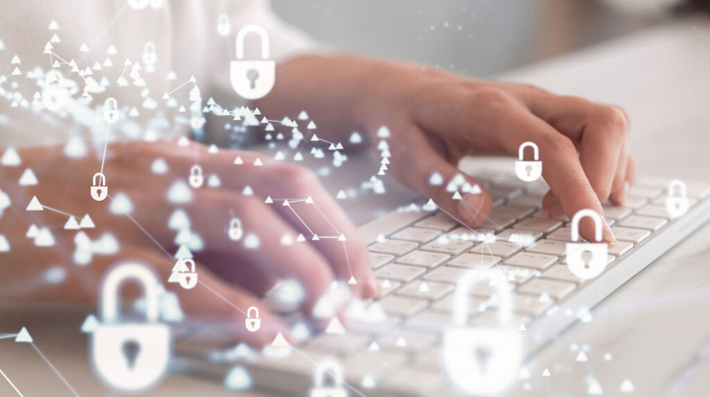 Closeup of person typing on white keyboard with glowing lock icons overlaid.