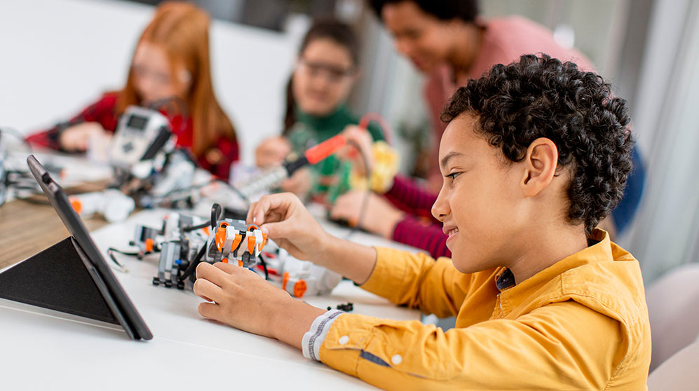 Elementary-aged child doing a robotics project