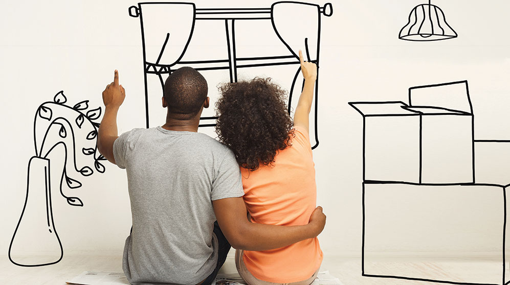 seated couple facing a wall and seemingly line drawing features of a home with fingers