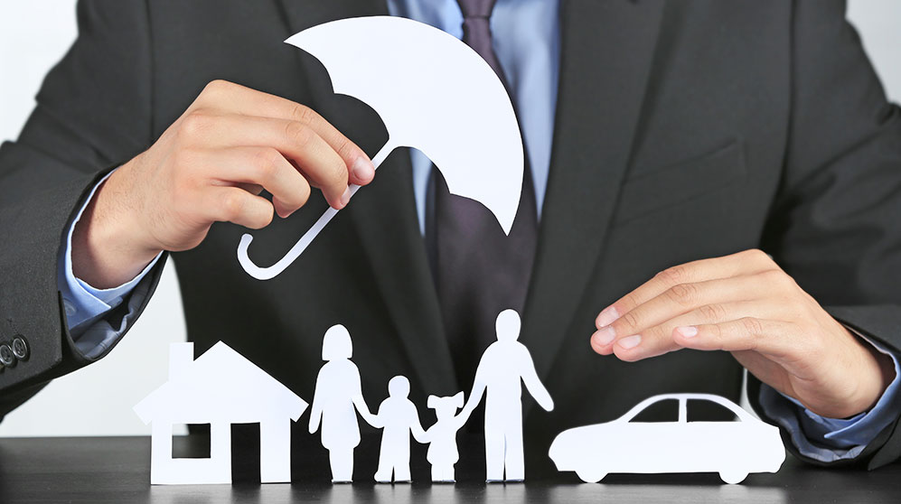 Person holding umbrella over house, family and car