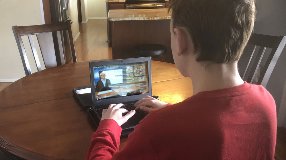 Student in class remotely with a computer