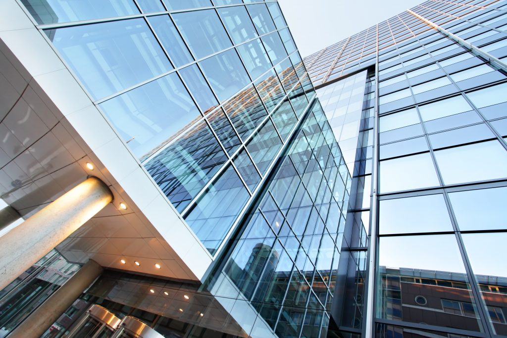 View up a large glass office building.